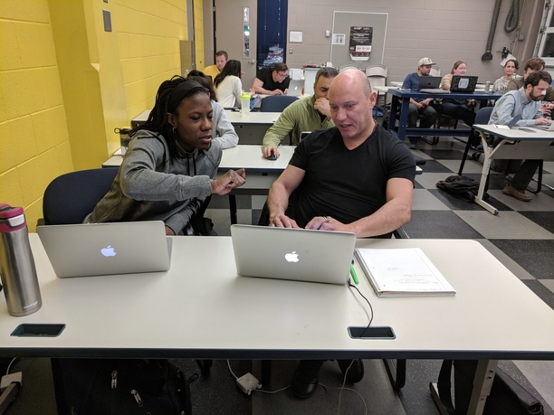 teacher helping student with computer